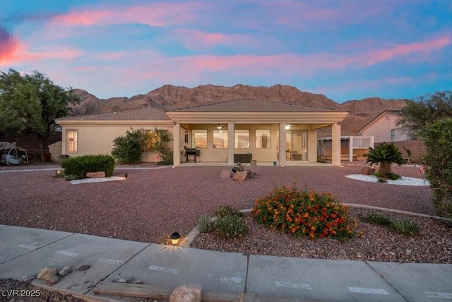835 Market Crest Dr, Las Vegas, NV 89110 - rear view of house with a mountain view, covered porch, and stucco siding