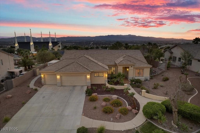 835 Market Crest Dr, Las Vegas, NV 89110 - view of front of house with a garage, driveway, a tile roof, stucco siding, and a mountain view