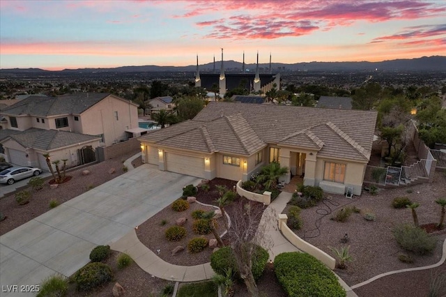 835 Market Crest Dr, Las Vegas, NV 89110 - view of front facade featuring an attached garage, a tile roof, driveway, and a mountain view