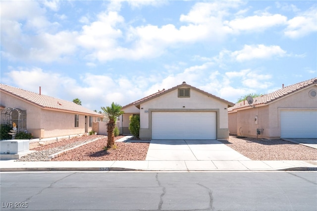 5524 La Pelusa St, North Las Vegas, NV 89031 - view of front of property with driveway, a garage, stucco siding, and a tiled roof