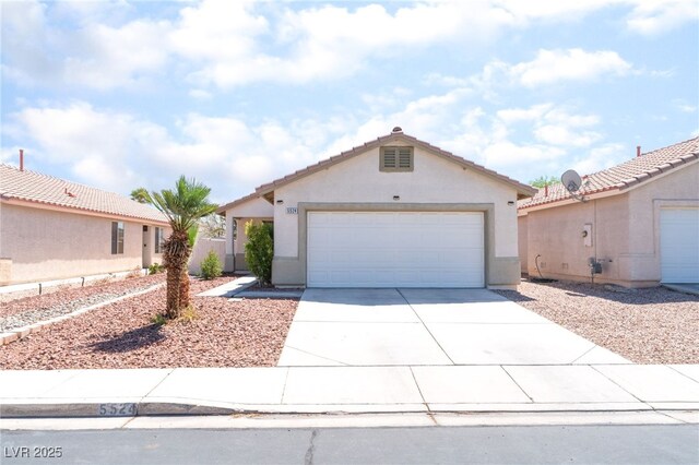 5524 La Pelusa St, North Las Vegas, NV 89031 - view of front of home with concrete driveway, stucco siding, a garage, and a tile roof