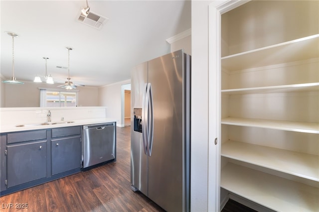 5524 La Pelusa St, North Las Vegas, NV 89031 - kitchen with stainless steel appliances, a sink, dark wood-style flooring, pendant lighting, and light countertops