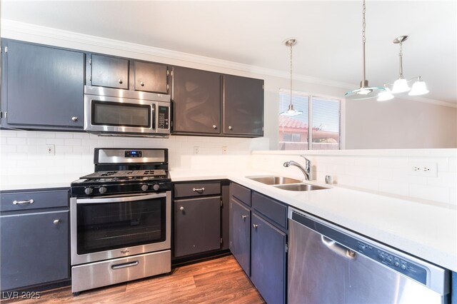 5524 La Pelusa St, North Las Vegas, NV 89031 - kitchen with appliances with stainless steel finishes, crown molding, a sink, tasteful backsplash, and light countertops