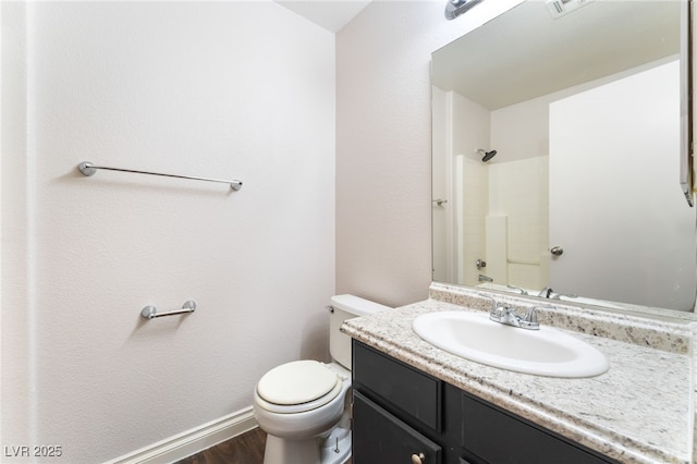 5524 La Pelusa St, North Las Vegas, NV 89031 - full bath with vanity, toilet, wood finished floors, a shower, and baseboards