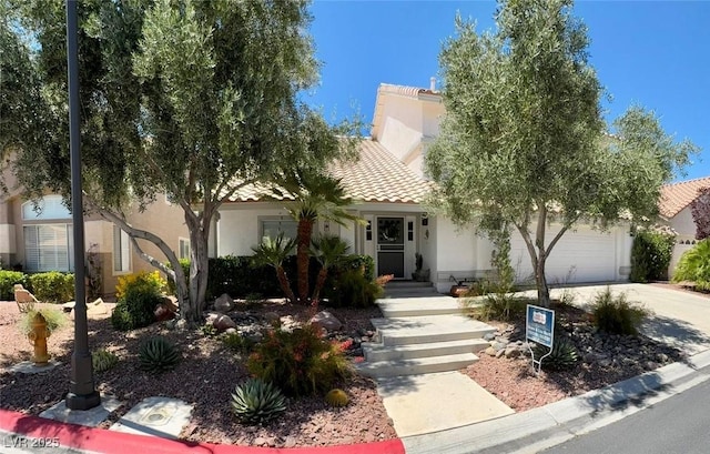 5041 Portraits Pl, Las Vegas, NV 89149 - obstructed view of property with stucco siding, a tiled roof, concrete driveway, and a garage