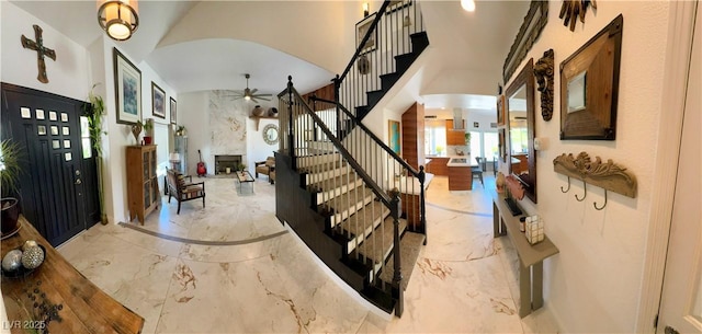 5041 Portraits Pl, Las Vegas, NV 89149 - entrance foyer with marble tiled flooring, stairway, ceiling fan, a towering ceiling, and a large fireplace