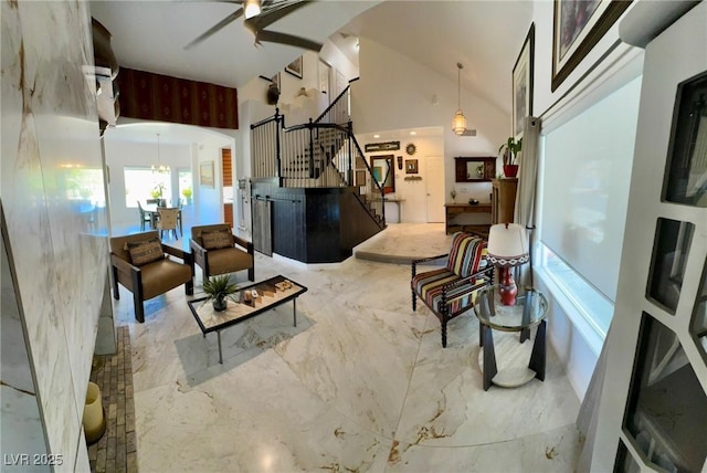 5041 Portraits Pl, Las Vegas, NV 89149 - living room with stairs, arched walkways, a ceiling fan, vaulted ceiling, and a chandelier