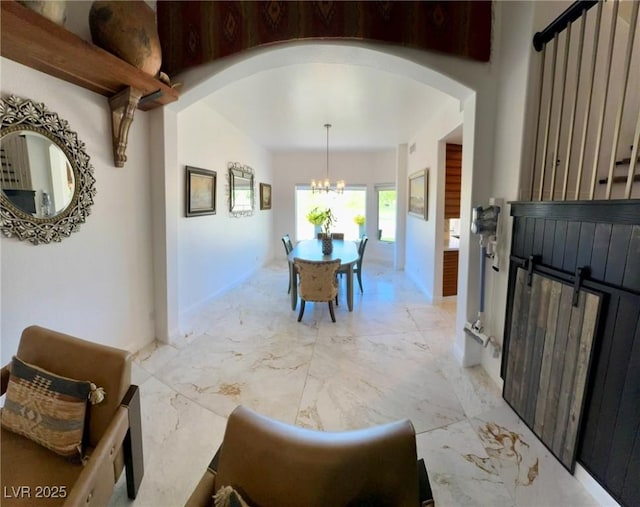 5041 Portraits Pl, Las Vegas, NV 89149 - interior space with arched walkways, a chandelier, and light marble finish flooring