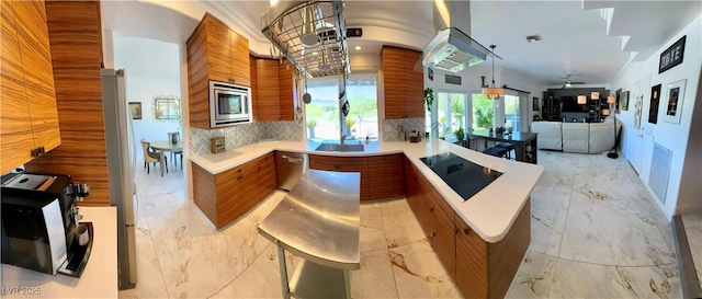 5041 Portraits Pl, Las Vegas, NV 89149 - kitchen featuring modern cabinets, stainless steel appliances, brown cabinets, a peninsula, and light countertops