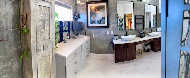 5041 Portraits Pl, Las Vegas, NV 89149 - bathroom featuring double vanity, marble finish flooring, and tile walls
