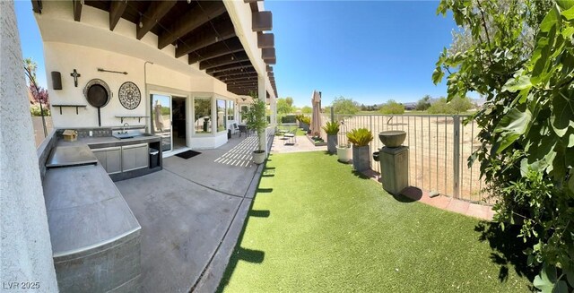 5041 Portraits Pl, Las Vegas, NV 89149 - view of yard featuring an outdoor kitchen and a patio