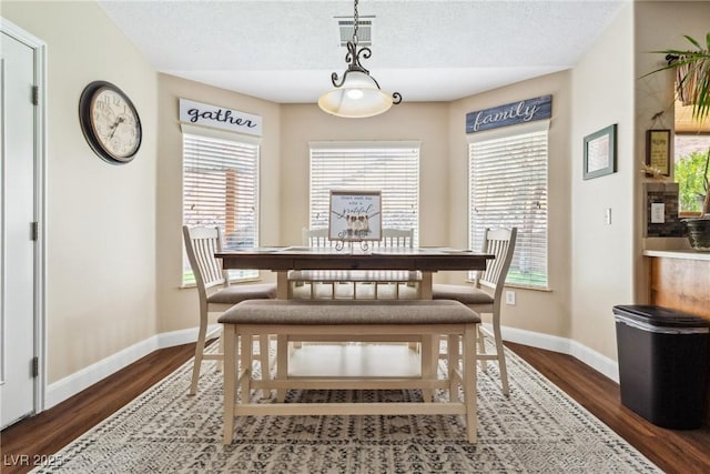 574 Desert Tortoise Way, Mesquite, NV 89027 - dining room with dark wood finished floors, baseboards, and a textured ceiling