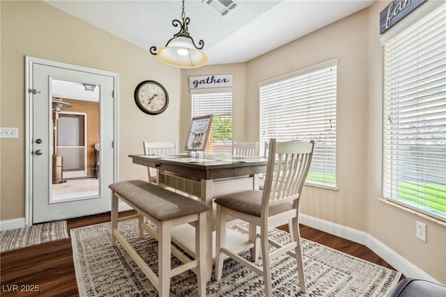 574 Desert Tortoise Way, Mesquite, NV 89027 - dining area with dark wood-type flooring, baseboards, healthy amount of natural light, and vaulted ceiling