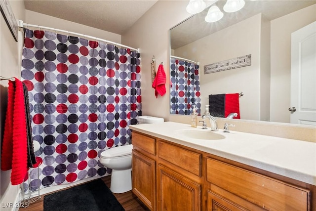574 Desert Tortoise Way, Mesquite, NV 89027 - bathroom featuring toilet, vanity, wood finished floors, and a shower with curtain