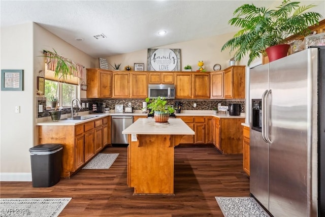 574 Desert Tortoise Way, Mesquite, NV 89027 - kitchen with appliances with stainless steel finishes, a sink, a center island, lofted ceiling, and dark wood finished floors
