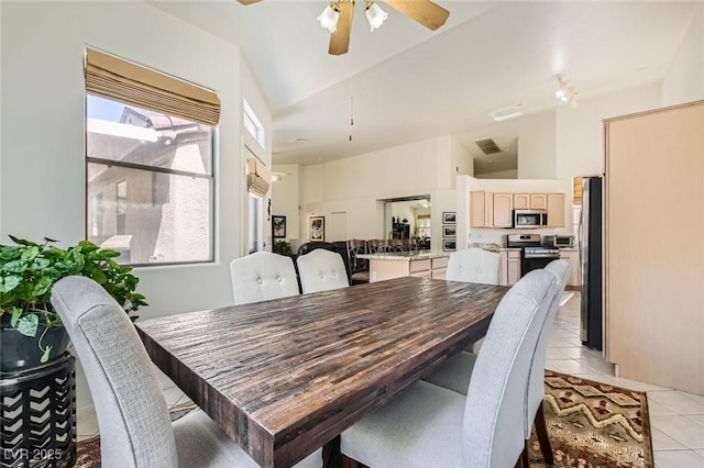 7515 Splashing Rock Dr, Las Vegas, NV 89131 - dining area featuring light tile patterned flooring, a ceiling fan, and high vaulted ceiling