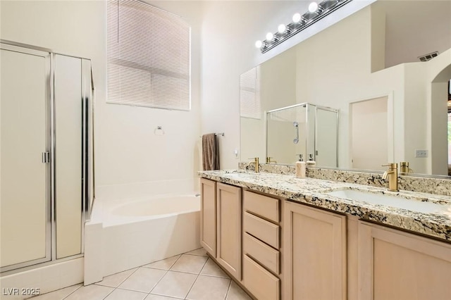 7515 Splashing Rock Dr, Las Vegas, NV 89131 - full bathroom with a shower stall, double vanity, a garden tub, and tile patterned floors