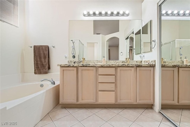 7515 Splashing Rock Dr, Las Vegas, NV 89131 - full bathroom featuring a shower stall, tile patterned floors, a garden tub, and double vanity