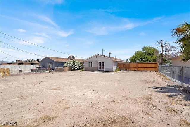 2257 Colebrook St, Las Vegas, NV 89115 - rear view of house with french doors and a fenced backyard