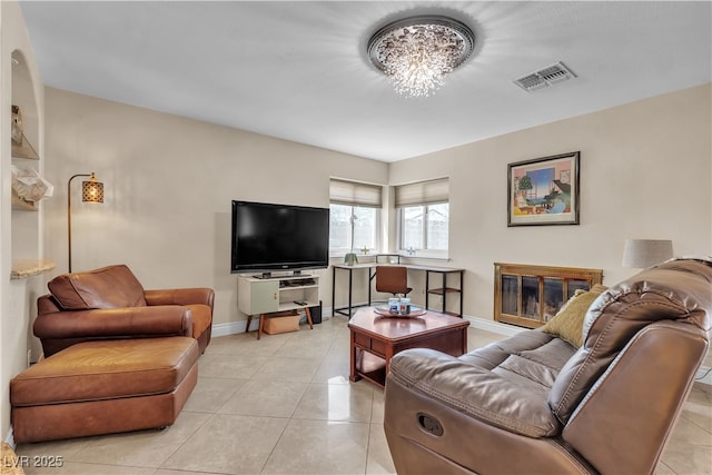 7197 Sixshooter Dr, Las Vegas, NV 89119 - living room with light tile patterned flooring, baseboards, a chandelier, and a glass covered fireplace