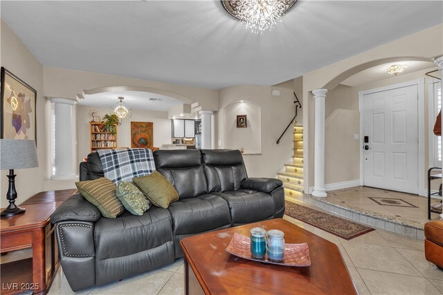 7197 Sixshooter Dr, Las Vegas, NV 89119 - living room featuring ornate columns, arched walkways, light tile patterned floors, and stairway