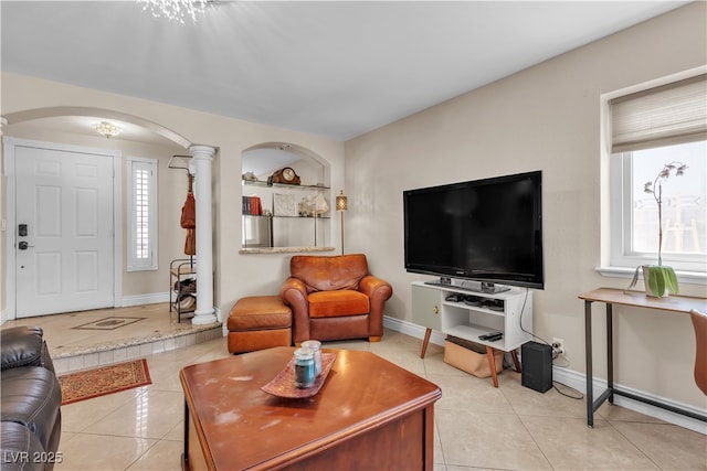 7197 Sixshooter Dr, Las Vegas, NV 89119 - living area featuring arched walkways, decorative columns, and plenty of natural light