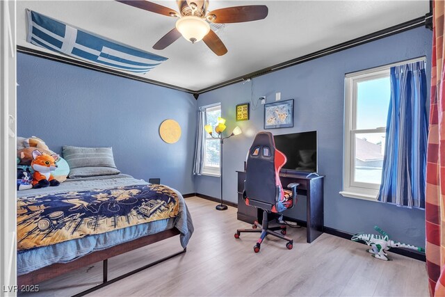 7197 Sixshooter Dr, Las Vegas, NV 89119 - bedroom with multiple windows, wood finished floors, crown molding, a ceiling fan, and baseboards