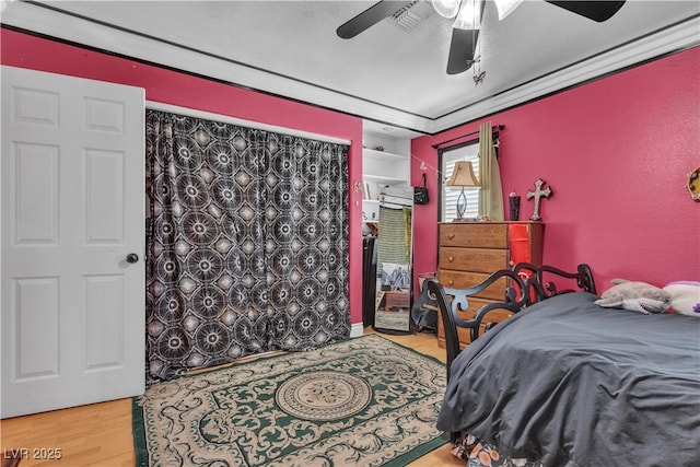 7197 Sixshooter Dr, Las Vegas, NV 89119 - bedroom with wood finished floors, a ceiling fan, and ornamental molding