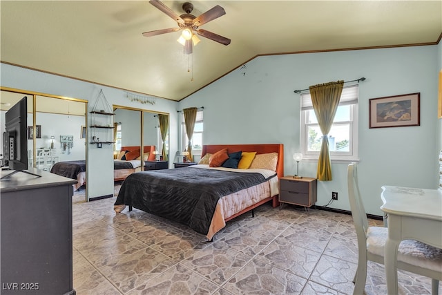 7197 Sixshooter Dr, Las Vegas, NV 89119 - bedroom featuring vaulted ceiling, multiple windows, two closets, ceiling fan, and light stone finish flooring