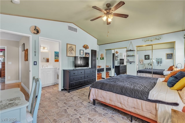 7197 Sixshooter Dr, Las Vegas, NV 89119 - bedroom with vaulted ceiling, multiple closets, a sink, baseboards, and ceiling fan