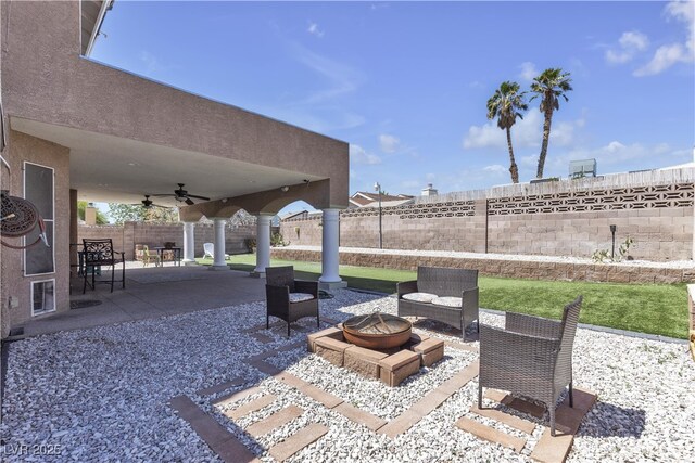 7197 Sixshooter Dr, Las Vegas, NV 89119 - fenced backyard featuring an outdoor fire pit, a patio, and a ceiling fan