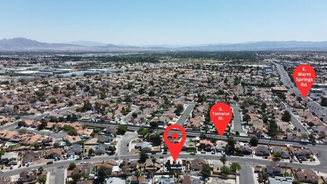 7197 Sixshooter Dr, Las Vegas, NV 89119 - aerial overview of property's location with a mountain backdrop and nearby suburban area