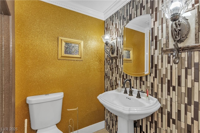 7197 Sixshooter Dr, Las Vegas, NV 89119 - bathroom with ornamental molding, toilet, wallpapered walls, baseboards, and a sink