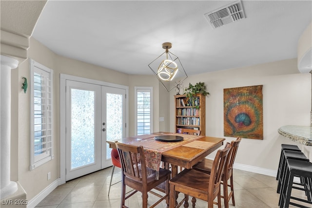 7197 Sixshooter Dr, Las Vegas, NV 89119 - dining space with light tile patterned floors, french doors, and baseboards