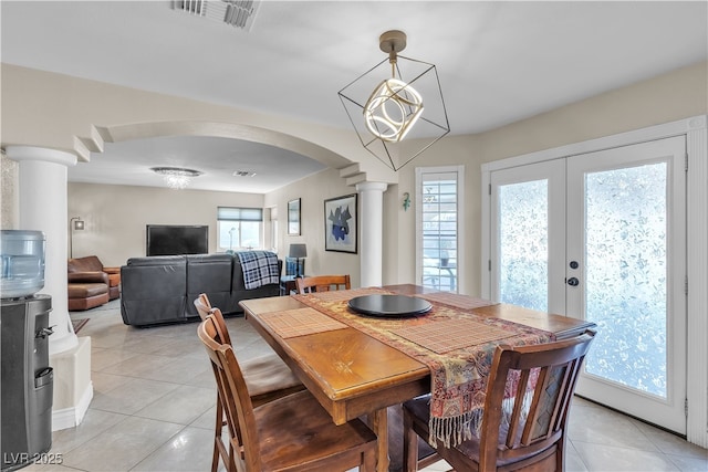 7197 Sixshooter Dr, Las Vegas, NV 89119 - dining space featuring ornate columns, light tile patterned floors, arched walkways, and french doors