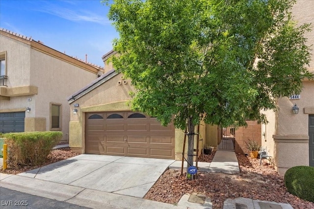 5452 Tinker Toy Ave, Las Vegas, NV 89139 - view of front facade with concrete driveway, an attached garage, stucco siding, and a gate