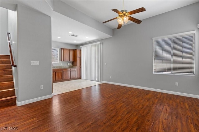 5452 Tinker Toy Ave, Las Vegas, NV 89139 - unfurnished living room with ceiling fan, light wood finished floors, stairway, baseboards, and recessed lighting