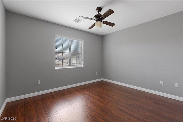 5452 Tinker Toy Ave, Las Vegas, NV 89139 - unfurnished room with dark wood-style flooring, a ceiling fan, and baseboards
