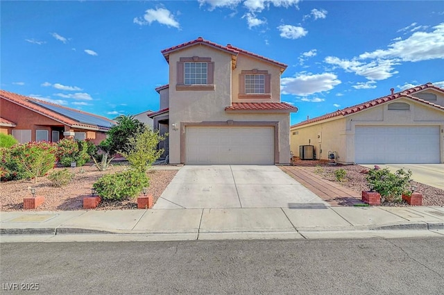 1025 Clover Tip Ct, Las Vegas, NV 89123 - mediterranean / spanish-style house featuring a tiled roof, central air condition unit, stucco siding, concrete driveway, and a garage