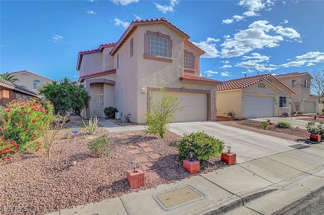 1025 Clover Tip Ct, Las Vegas, NV 89123 - mediterranean / spanish home with a tile roof, stucco siding, driveway, and an attached garage