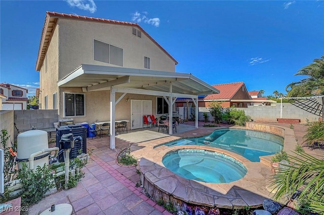 1025 Clover Tip Ct, Las Vegas, NV 89123 - rear view of house featuring stucco siding, a patio area, a fenced backyard, and a pool with connected hot tub