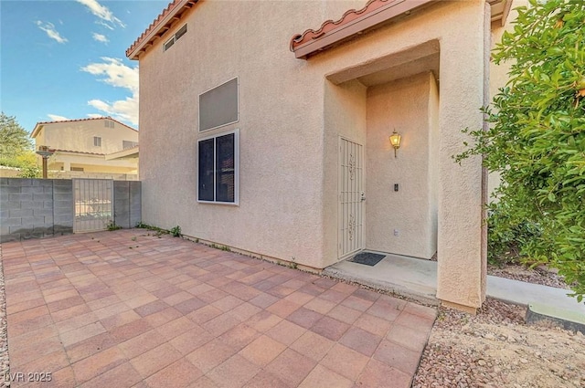 1025 Clover Tip Ct, Las Vegas, NV 89123 - doorway to property with stucco siding, a patio, a tile roof, and a gate