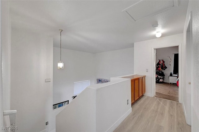 1025 Clover Tip Ct, Las Vegas, NV 89123 - hall featuring an upstairs landing, light wood-style floors, baseboards, and attic access