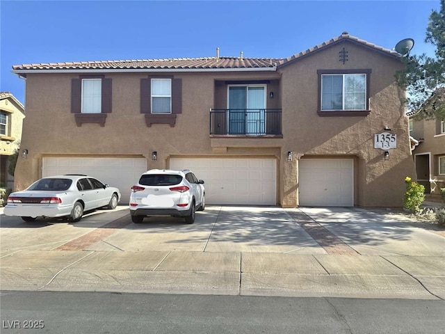 1355 Grass Creek Ave Unit 1, Henderson, NV 89012 - view of front of house with a garage, stucco siding, driveway, and a tile roof