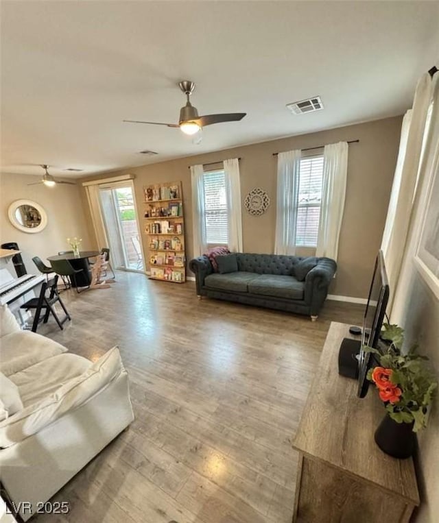 1355 Grass Creek Ave Unit 1, Henderson, NV 89012 - living area with a ceiling fan, light wood-type flooring, and baseboards