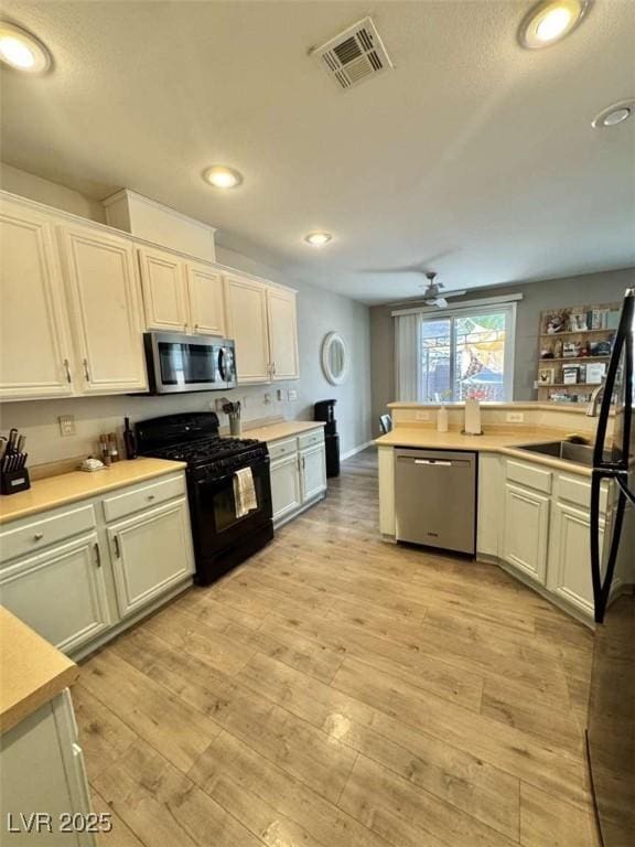 1355 Grass Creek Ave Unit 1, Henderson, NV 89012 - kitchen featuring black appliances, light countertops, ceiling fan, and recessed lighting