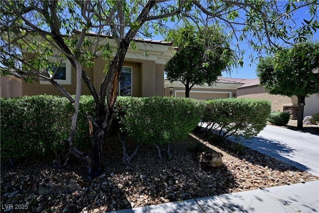 7727 Widewing Dr, North Las Vegas, NV 89084 - view of side of property featuring stucco siding and an attached garage