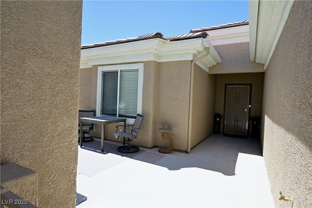 7727 Widewing Dr, North Las Vegas, NV 89084 - view of exterior entry with stucco siding and a patio