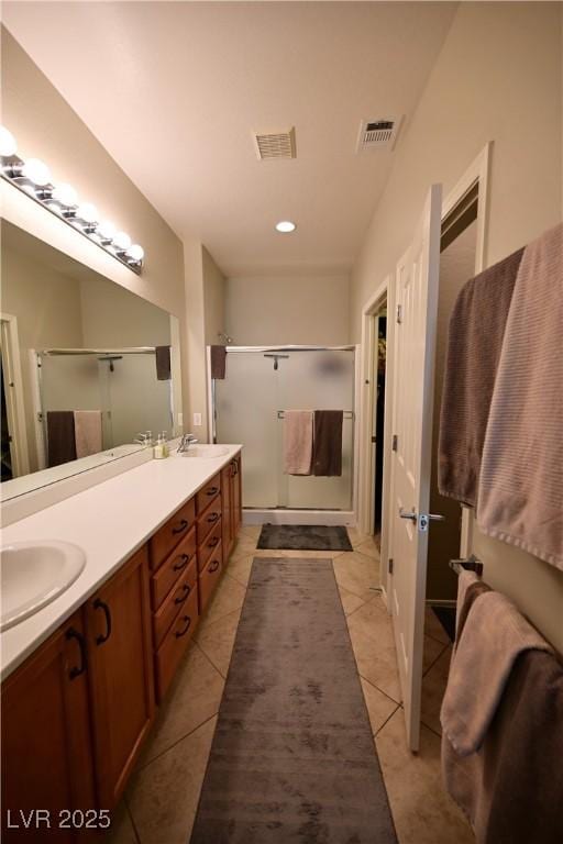 7727 Widewing Dr, North Las Vegas, NV 89084 - full bathroom featuring a shower stall, double vanity, tile patterned floors, and recessed lighting