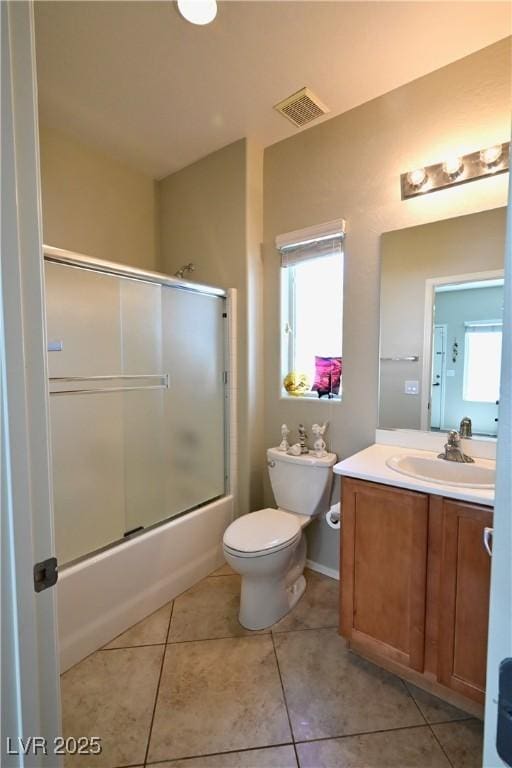 7727 Widewing Dr, North Las Vegas, NV 89084 - full bath with toilet, vanity, combined bath / shower with glass door, and tile patterned floors